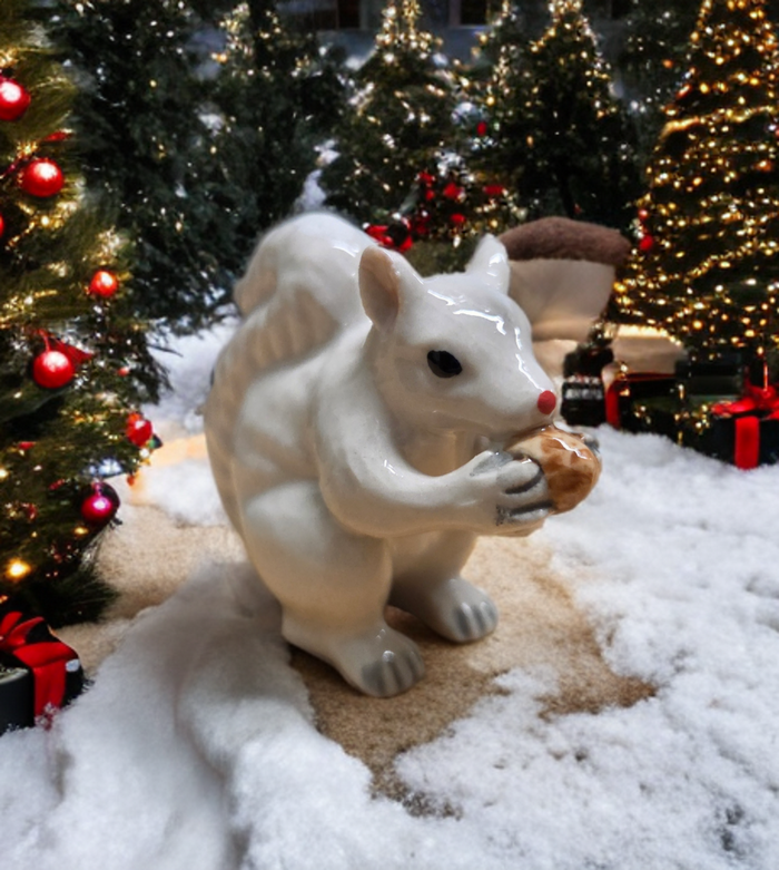 White squirrel porcelain ornament holding a nut