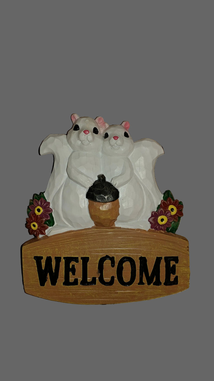 A resin wall hanging featuring a white squirrel on a welcome plaque with the word 'WELCOME' displayed.